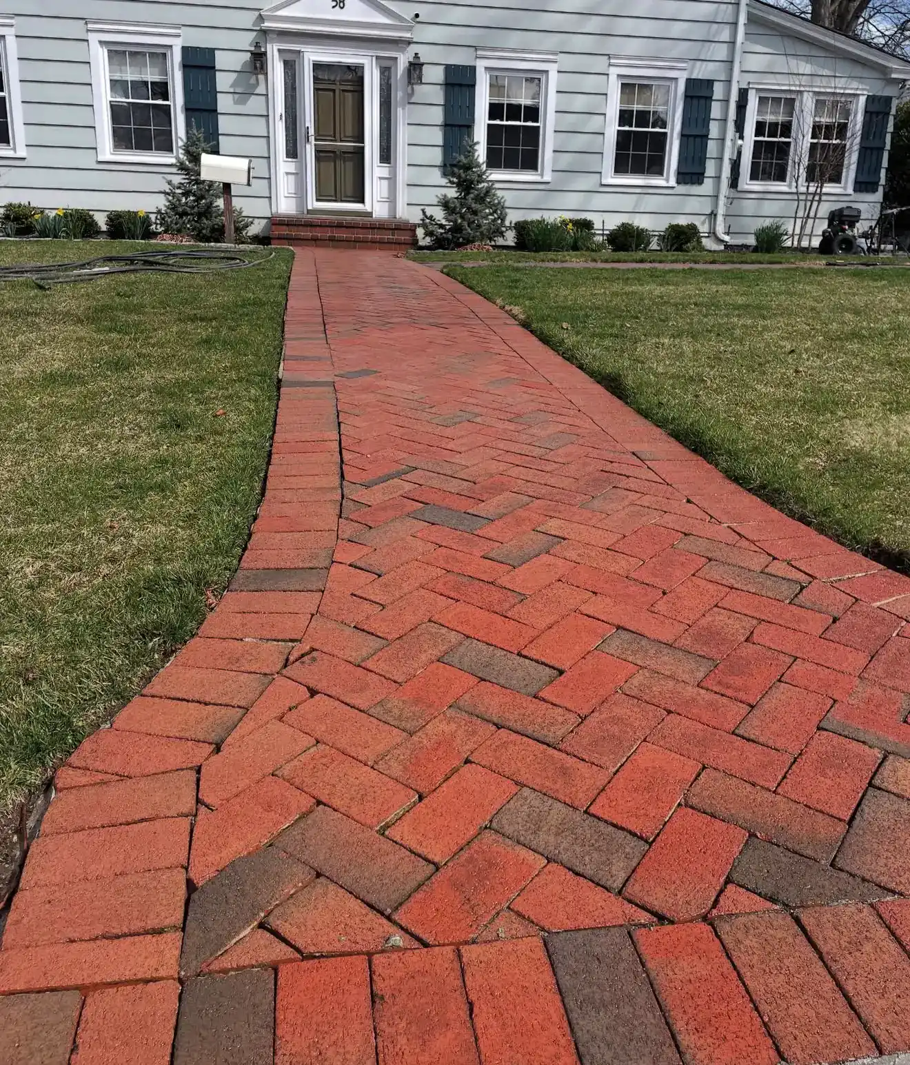 Power washing brick walkway for a clean, refreshed appearance. Expert exterior cleaning services by.