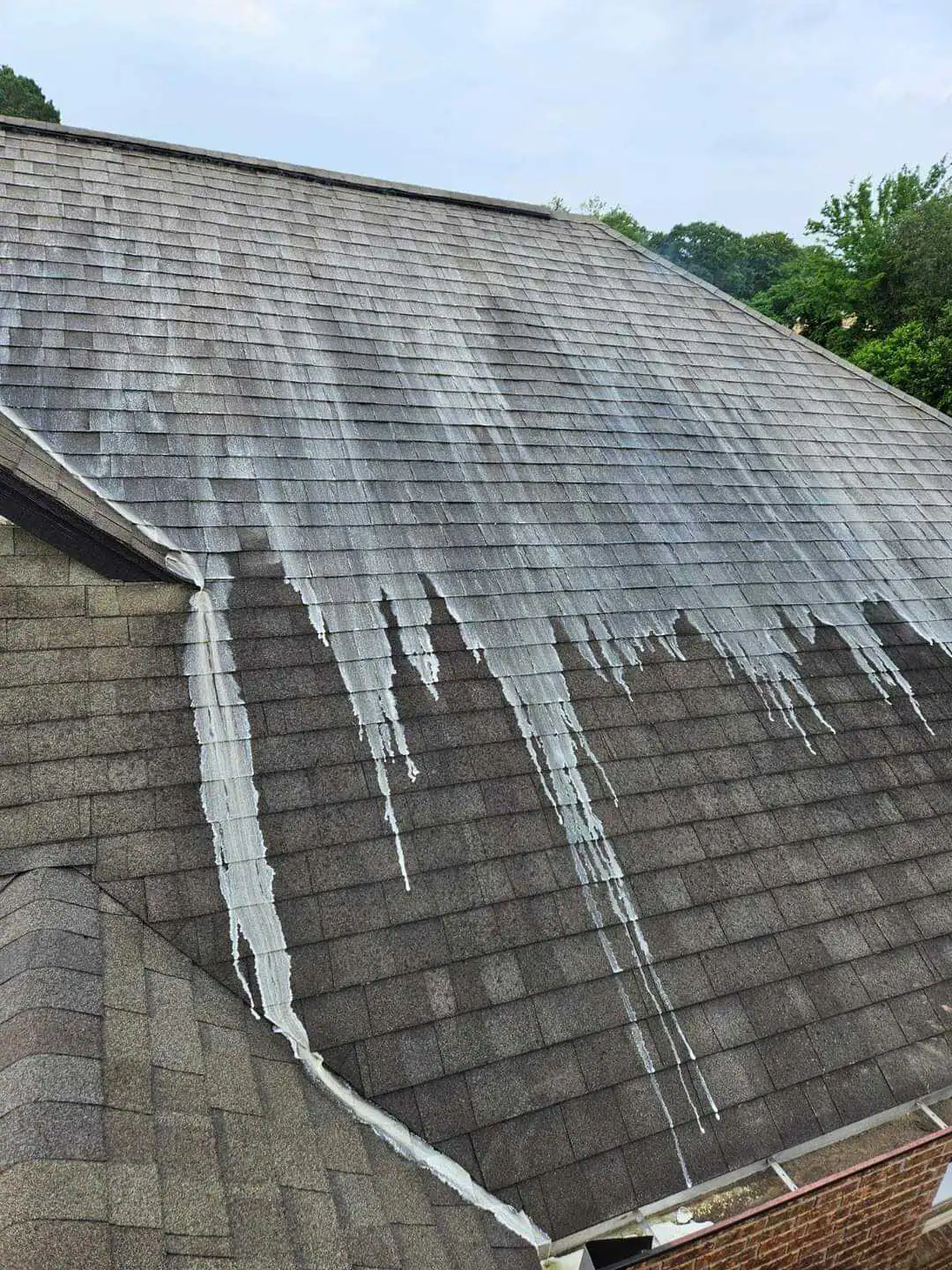 Roof cleaning with power washing to remove stains, moss, and algae for a cleaner, brighter roof.